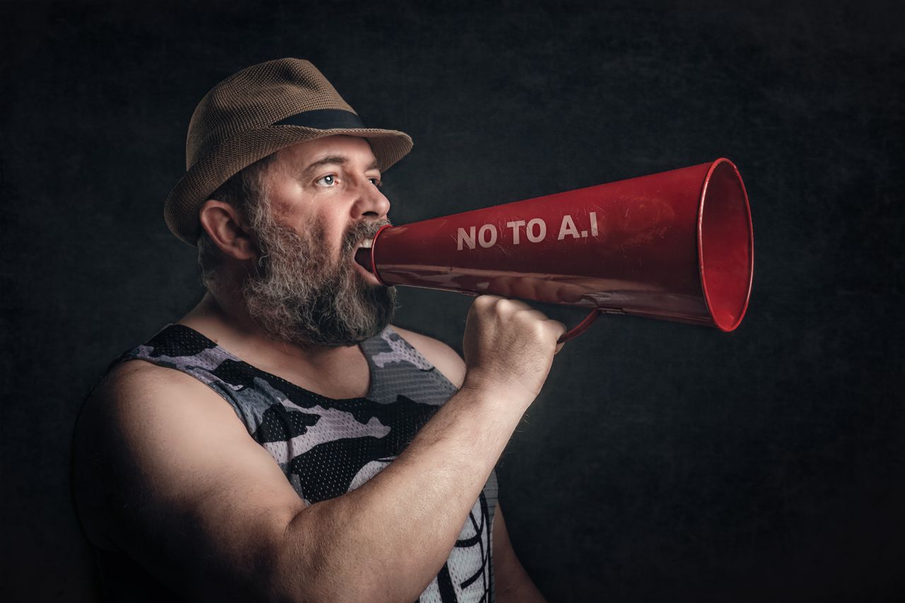 Bearded man shouting through a red megaphone with No to A.I message.
